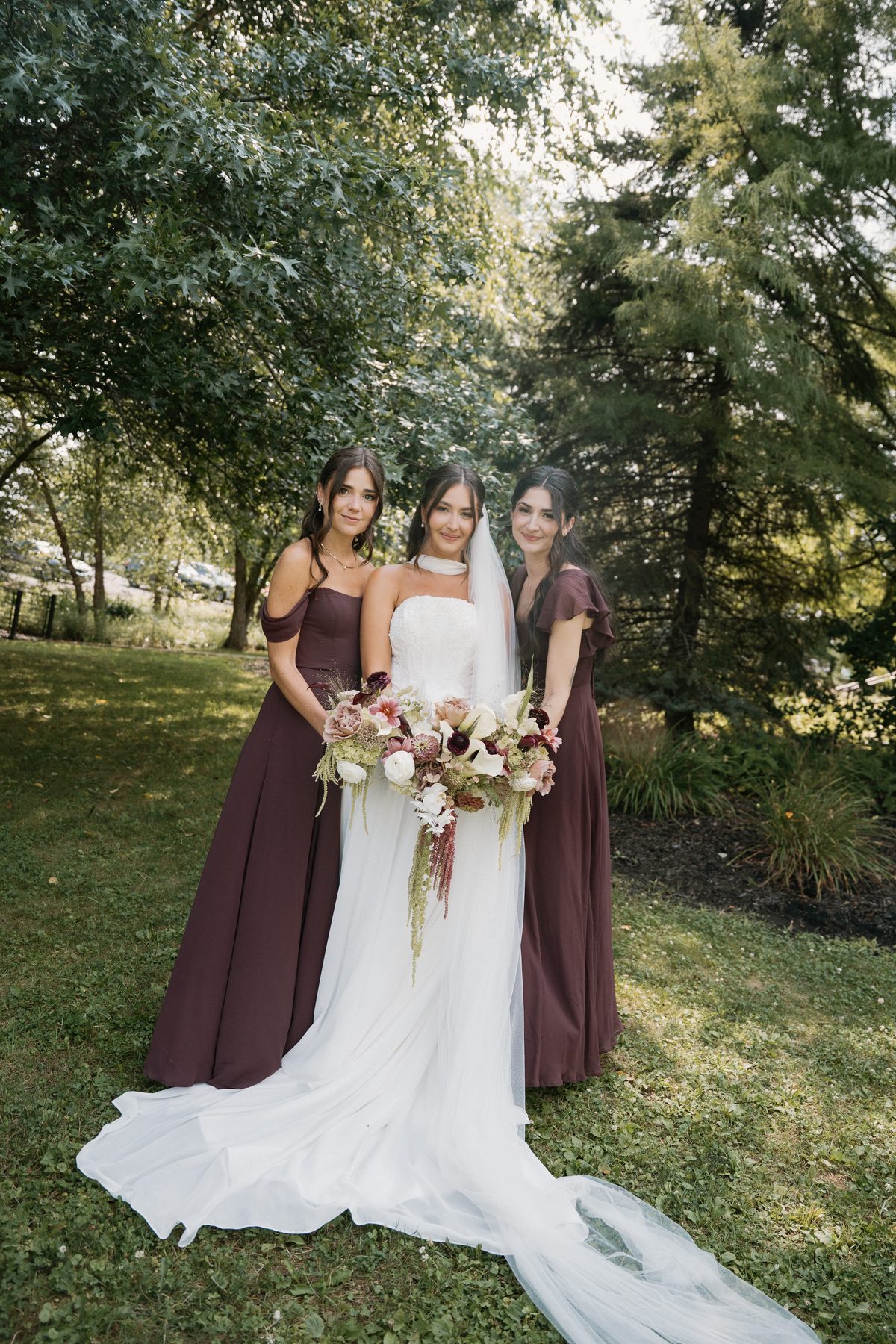 Bride with her bridesmaids in burgundy gowns — bridal party makeup, Pittsburgh PA